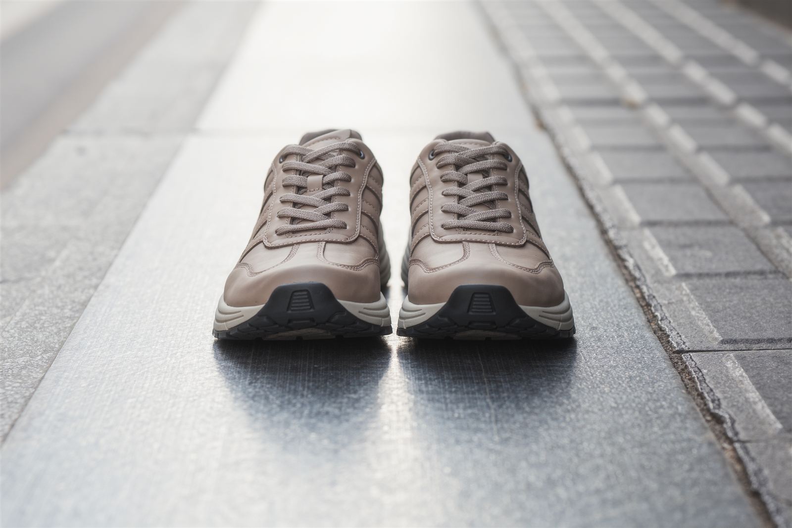 A pair of walking shoes standing on a city sidewalk